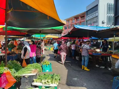 a group of people walking around a market with produce at Continew TRX Corner Dual Balconies 2 Bedrooms in Kuala Lumpur