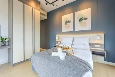 a bedroom with a large bed with a table on it at Continew TRX Corner Dual Balconies 2 Bedrooms in Kuala Lumpur