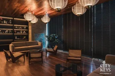 a living room with a couch and chairs and chandeliers at Alfa Bangsar by City Keys in Kuala Lumpur