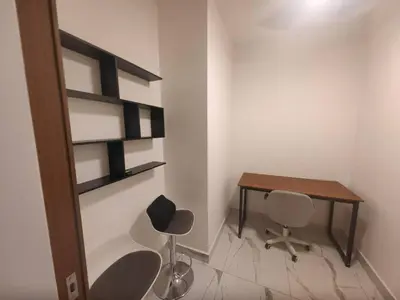 a room with a desk and two chairs and a table at Alfa Bangsar by City Keys in Kuala Lumpur