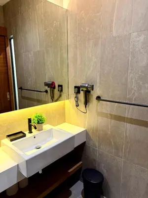 a bathroom with a white sink and a mirror at Alfa Bangsar by City Keys in Kuala Lumpur