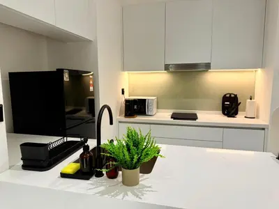 a kitchen with a counter with a sink and a microwave at Alfa Bangsar by City Keys in Kuala Lumpur