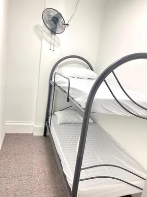 a room with two bunk beds and a lamp at Bright Star Inn in Kuala Lumpur