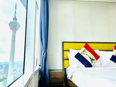 a bedroom with a bed with a view of the seoul tower at KLCC Vortex Suites Residence in Kuala Lumpur