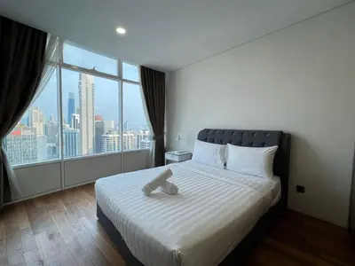 a bedroom with a large bed with a large window at KLCC Vortex Suites Residence in Kuala Lumpur