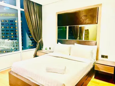 a bedroom with a large white bed with a window at KLCC Vortex Suites Residence in Kuala Lumpur