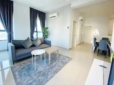 a living room with a blue couch and a table at Arte plus by dream stay in Kuala Lumpur