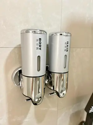 two silver cups hanging on a wall in a bathroom at ONE18 Boutique Hotel in Kuala Lumpur