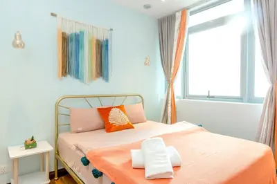 a bedroom with a bed with an orange blanket at My home at Kuala Lumpur in Kuala Lumpur