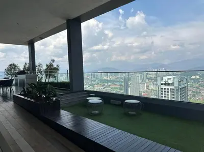 a balcony with two tables and a view of a city at Cozy Comfy & Affordable Place at KLCC in Kuala Lumpur