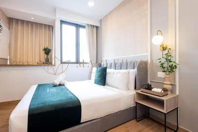 a bedroom with a large bed in a room at Riveria Premier Suites Kuala Lumpur in Kuala Lumpur