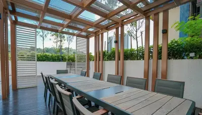 a conference room with a wooden table and chairs at Inspirasi at Mont Kiara by Airhost in Kuala Lumpur