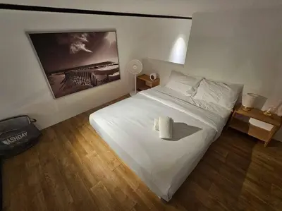 a bedroom with a white bed with a candle on it at SkyView Studio, EST Bangsar, High View for 2 in Kuala Lumpur