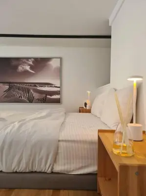 a bedroom with a bed with a picture on the wall at SkyView Studio, EST Bangsar, High View for 2 in Kuala Lumpur