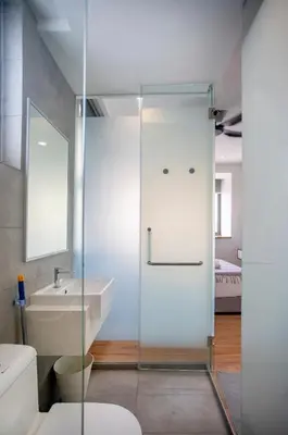 a glass shower door in a bathroom with a sink at Riveria City near KL Sentral with 118 view Sky Infinity Pool by COBNB in Kuala Lumpur