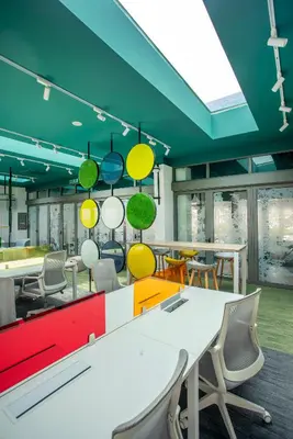 a conference room with colorful tables and chairs at Riveria City near KL Sentral with 118 view Sky Infinity Pool by COBNB in Kuala Lumpur