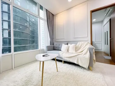 a living room with a couch and a table at Sky Suites Airy 2BR Suite at KLCC in Kuala Lumpur