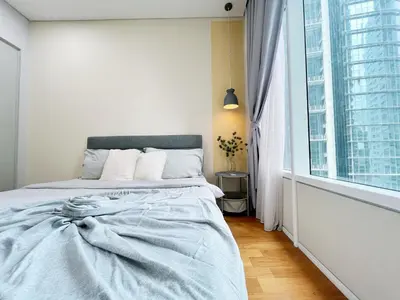 a white bedroom with a bed and a large window at Sky Suites Airy 2BR Suite at KLCC in Kuala Lumpur