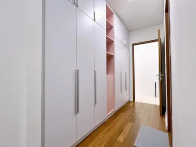 a hallway with white cabinets and a door at Sky Suites Blush 3BR Suite at KLCC in Kuala Lumpur