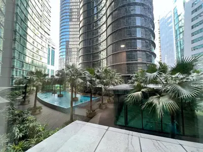 a view of a city with palm trees and buildings at Sky Suites Blush 3BR Suite at KLCC in Kuala Lumpur