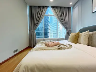 a bedroom with a large bed with a large window at Sky Suites Calm 2BR Suite at KLCC in Kuala Lumpur