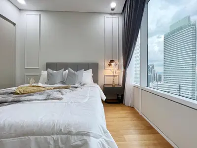 a bedroom with a large bed and a large window at Sky Suites Central 2BR Suite KLCC View in Kuala Lumpur