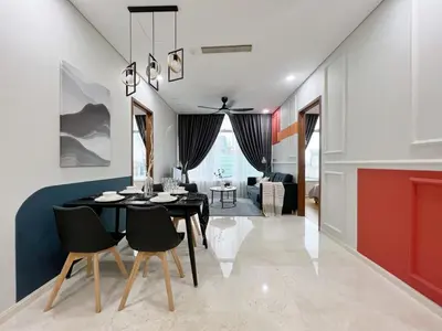 a dining room and living room with a black table and chairs at Sky Suites Central 2BR Suite KLCC View in Kuala Lumpur