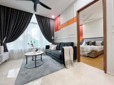 a living room with a couch and a bed at Sky Suites Central 2BR Suite KLCC View in Kuala Lumpur