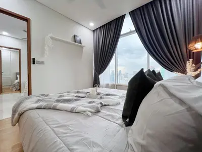 a bedroom with a large bed with a large window at Sky Suites Central 2BR Suite KLCC View in Kuala Lumpur