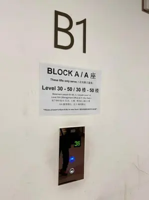 a sign on a wall with a clock on it at Facestyle Infinity Pool KLCC Smart TV Free WiFi Two Bedroom in Kuala Lumpur
