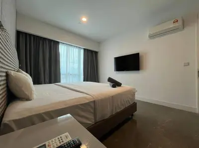 a hotel room with a bed and a tv at Facestyle Infinity Pool KLCC Smart TV Free WiFi Two Bedroom in Kuala Lumpur