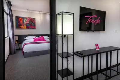 a hotel room with a bed and a sign that reads hotel at TEEDO Hotel Kuala Lumpur in Kuala Lumpur