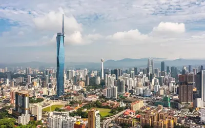 an aerial view of a city with a tall skyscraper at TEEDO Hotel Kuala Lumpur in Kuala Lumpur