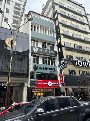 a city street with cars parked in front of a building at SS Grey Hotel Bukit Bintang in Kuala Lumpur