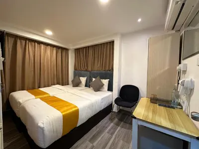 a hotel room with a bed and a chair at SS Grey Hotel Bukit Bintang in Kuala Lumpur