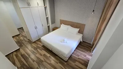 a small bedroom with a white bed and white cabinets at Bintang Goldhill Near TRX & Pavilion Mall,MRT,KL By Proplet in Kuala Lumpur