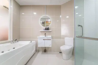 a bathroom with a tub and a toilet and a mirror at Relaxing Muji Retreat with Jacuzzi, Retro Games, MRT in Kuala Lumpur