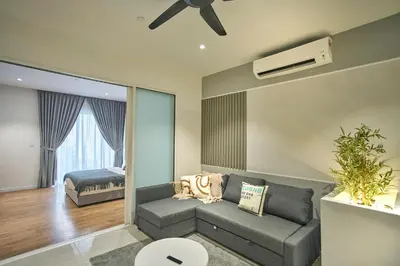a living room with a couch and a ceiling fan at Quill Residence Luxury Suite Kuala Lumpur by Cobnb in Kuala Lumpur