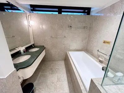 a bathroom with two sinks and a tub and a mirror at Times Square by Manhattan Group in Kuala Lumpur
