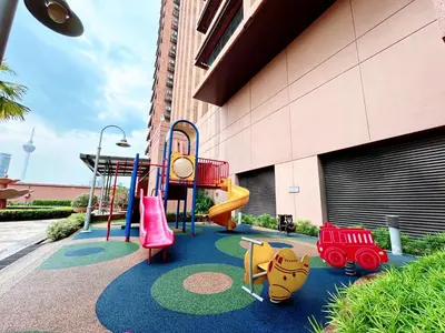 a playground with a slide and play equipment in front of a building at Times Square by Manhattan Group in Kuala Lumpur