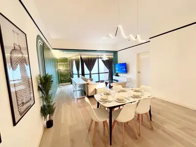 a dining room and living room with a table and chairs at Times Square by Manhattan Group in Kuala Lumpur