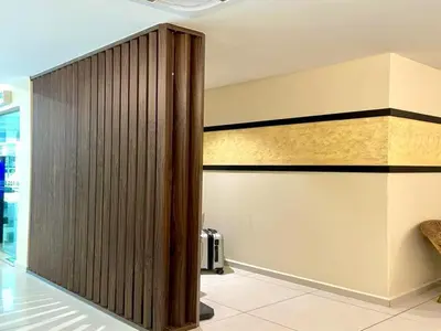 a wooden partition in a lobby with a wall at D'OR Hotel Tengkat Tong Shin in Kuala Lumpur