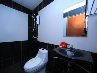 a bathroom with a sink and a toilet and a mirror at OYO 115 Hotel Safari 1 in Kuala Lumpur