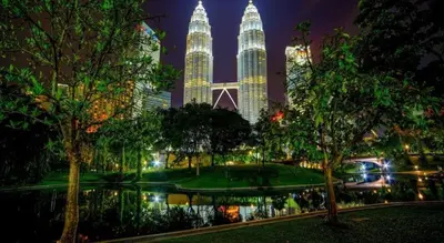 a view of a park at night with tall buildings at OYO 115 Hotel Safari 1 in Kuala Lumpur