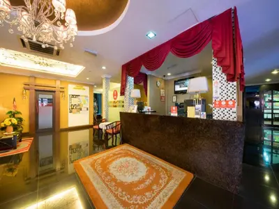 a lobby with a bar with red curtains at OYO 126 Rae Hotel in Kuala Lumpur