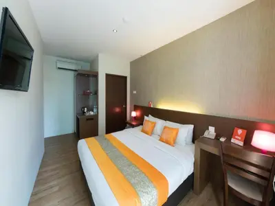 a bedroom with a large bed and a flat screen tv at OYO 139 The Marque Hotel in Kuala Lumpur