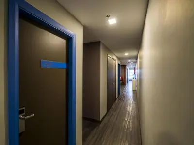 a hallway of an office with a door and a hallwayngthngthngthngthngth at OYO 264 City Edge Hotel in Kuala Lumpur