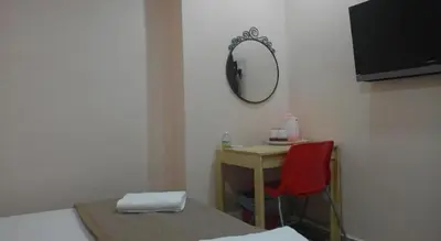 a room with a desk with a red chair and a mirror at Budget Star Hotel in Kuala Lumpur