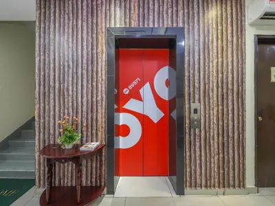 a red elevator with a red door and a table at OYO 89571 Eco Palace hotel in Kuala Lumpur