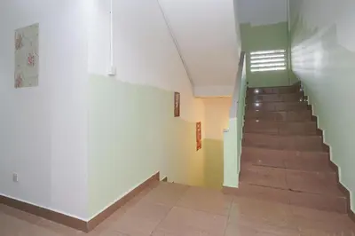 a hallway with a staircase in a building at OYO 90106 Sindbad Hotel in Kuala Lumpur